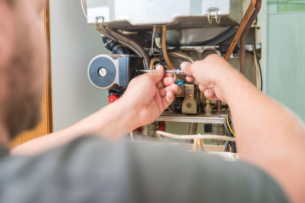 man working on a furnace