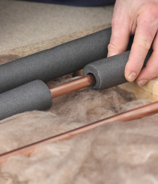 copper piping being covered by insullation